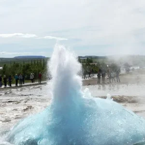 Geysir Geysir-Ausbruch im Golden Circle mit Touristen im Hintergrund und dampfender Geothermal-Landschaft
